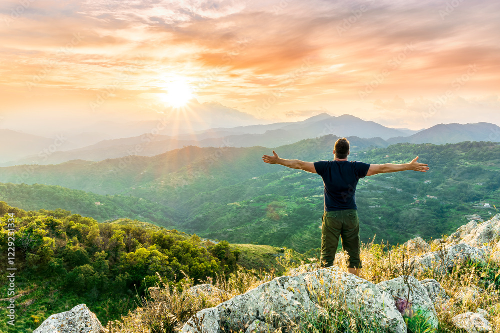 Obraz premium happy man watching amazing highland evening sunset, person delight with nature landscape