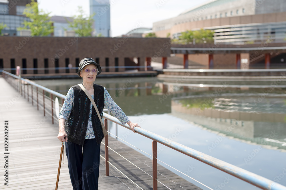 A park with good atmosphere with canal in Toyama Prefecture. Old Japanese woman in her 90s are walking around the park. A park with good atmosphere with canal in Toyama Prefecture. Old Japanese woman in her 90s are walking around the park.