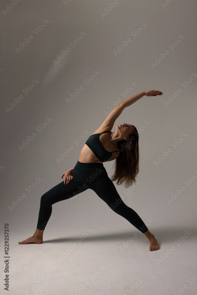 Portrait of sporty woman doing exercise in studio practicing yoga asana. Isolated. Portrait of sporty woman doing exercise in studio practicing yoga asana. Isolated.