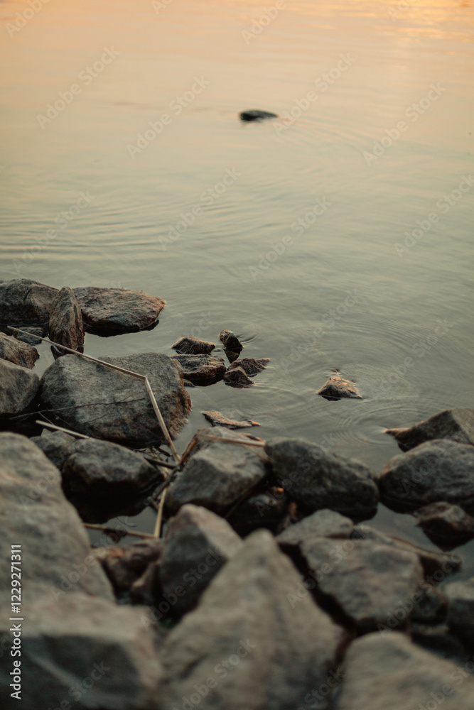 rocks in the lake with gentle ripples in the water rocks in the lake with gentle ripples in the water