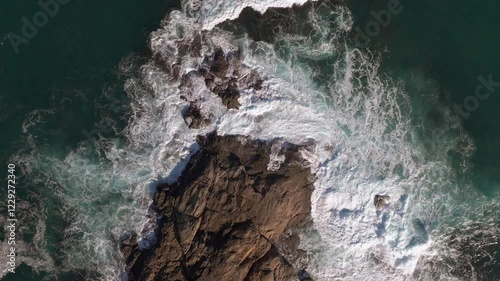 Top View Of Crashing Waves Hit Rocky Shores photo