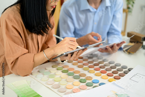 Creative team using digital tablet and reviewing color swatches at co working space photo