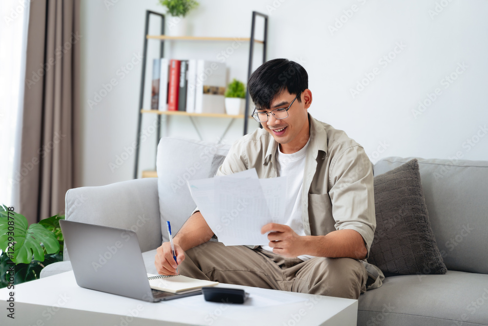 Man is calculating annual tax with calculator and filling form of Individual Income Tax Return. Man is calculating annual tax with calculator and filling form of Individual Income Tax Return.