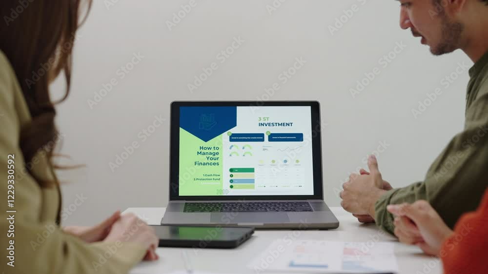 asian financial advisor presenting charts and data on a tablet during couple client meeting.financial planning and decision-making asian financial advisor presenting charts and data on a tablet during couple client meeting.financial planning and decision-making