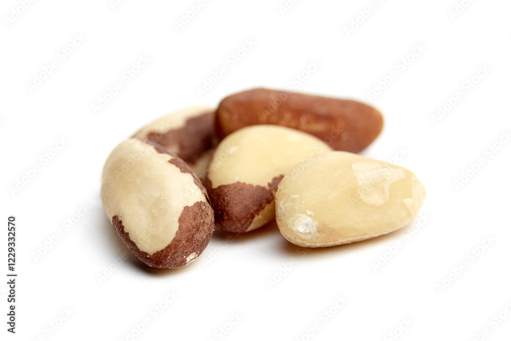 A cluster of raw Brazil nuts, featuring smooth ivory surfaces with brown shells, isolated on a white background. Natural textures and details visible A cluster of raw Brazil nuts, featuring smooth ivory surfaces with brown shells, isolated on a white background. Natural textures and details visible