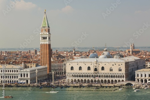 Top view of National Library of St Mark's or Biblioteca Nazionale Marciana, Campanile bell tower and Doge's Palace at St Mark's Square filled with tourists, San Marco district, Venice, Veneto, Italy, Europe photo