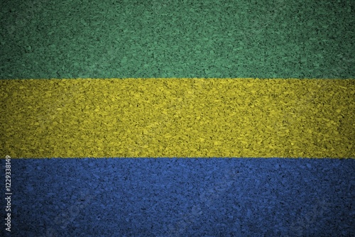 The Gabonese flag painted on a cork board