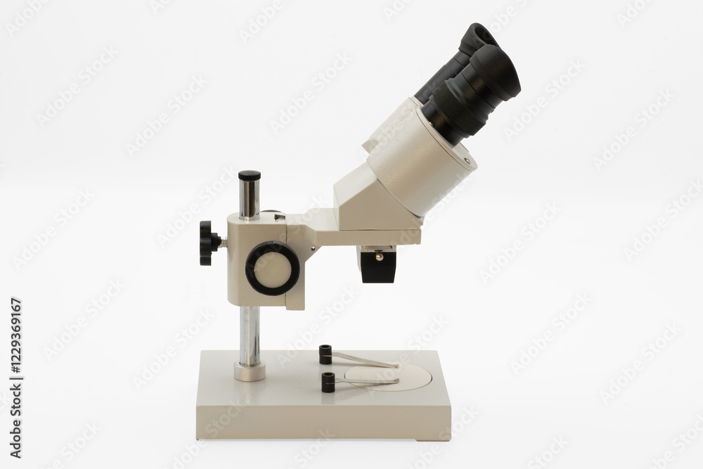 Optical microscope on a clean surface ready for scientific observation in a laboratory Isolated on white background Optical microscope on a clean surface ready for scientific observation in a laboratory Isolated on white background