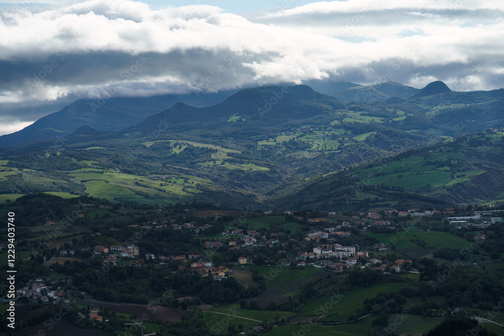 Fototapeta premium San Marino countryside with distant mountains under a cloudy sky