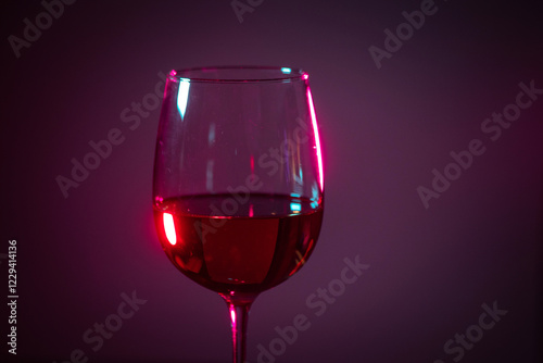 glass of pink wine on a colored background.