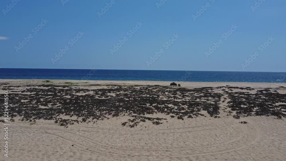Forward drone shot from desert beach towards sea featuring beautiful seascape. Forward drone shot from desert beach towards sea featuring beautiful seascape.
