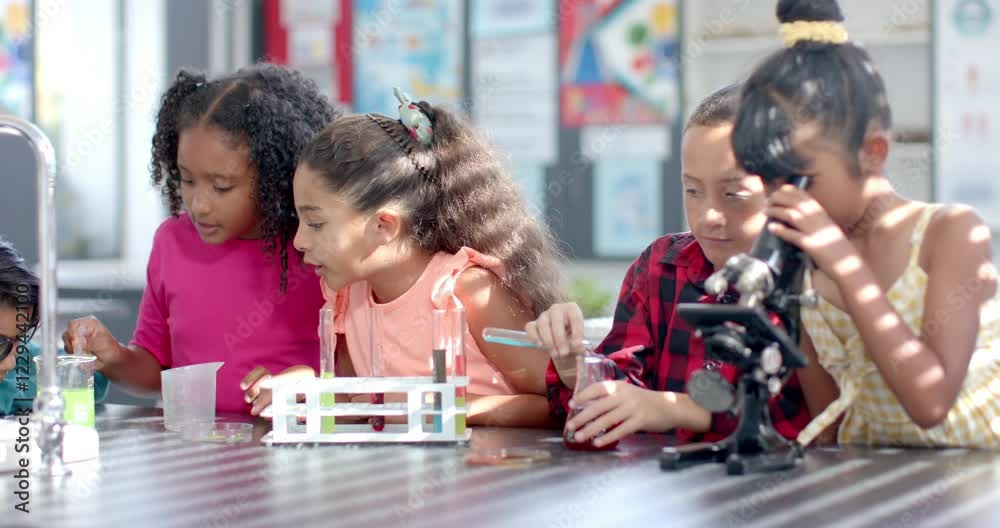 In school, in a classroom, a diverse group of young students engages in a chemistry experiment In school, in a classroom, a diverse group of young students engages in a chemistry experiment