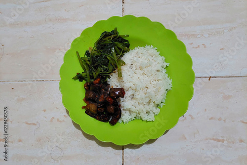 Eggplant lime rice on a green plate is ready to eat