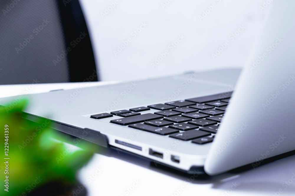 Laptop on a table in a modern office. Close-up Laptop on a table in a modern office. Close-up