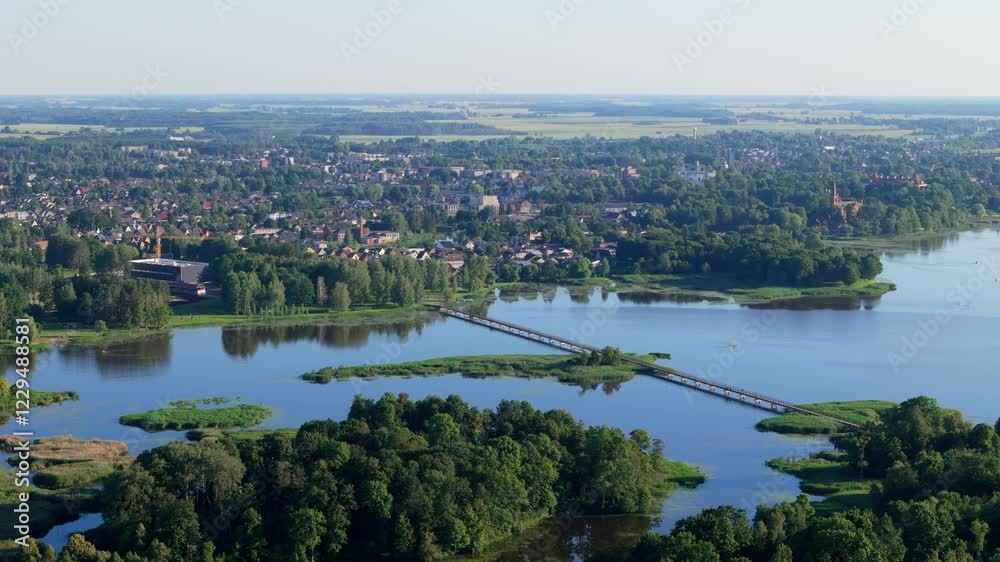 Parallax drone shot of the longest pedestrian bridge in Lithuania during day