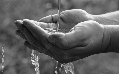 Canvas Print A man washes his hands at an outdoor washstand