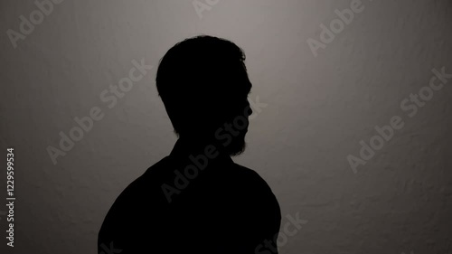 Man giving anonymous interview hiding identity. Portrait of unknown witness testifying to investigation.