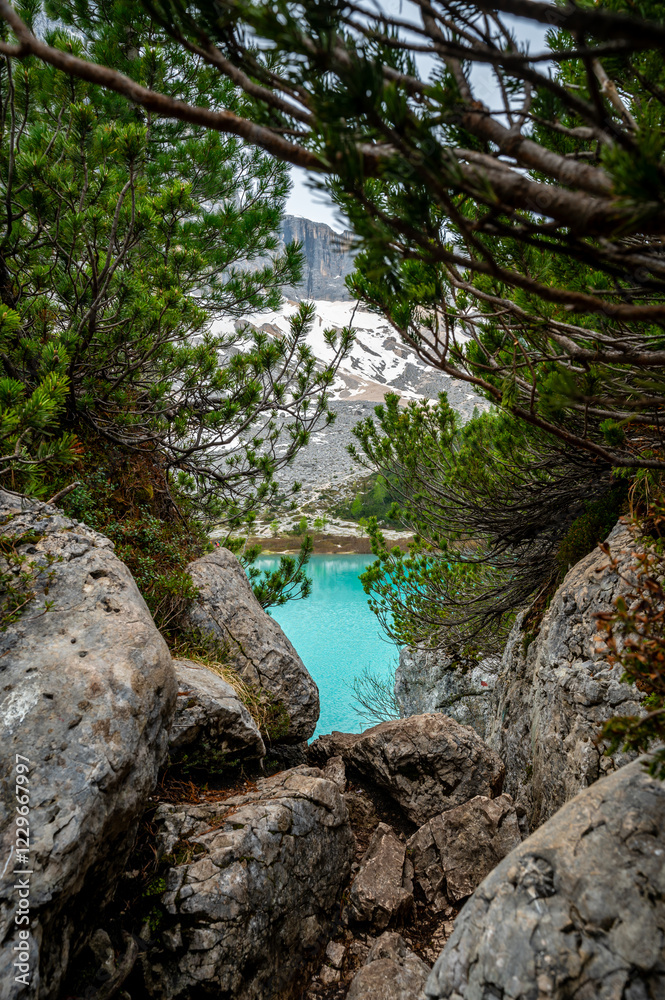 Panoramic view of Lago Sorapis in the Dolomites (Dolomiti, Dolomiten), Italy. The turquoise lake is surrounded by towering cliffs and mountains, a popular spot for hikers and nature lovers