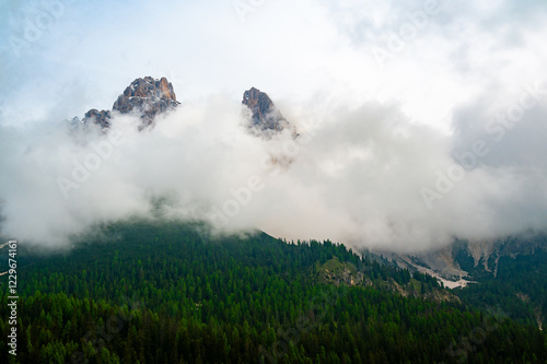 Obraz na płótnie Mountain trail in the Dolomites (Dolomiti, Dolomiten), Italy, leading to Lago Sorapis. The path winds along rocky slopes with stunning views of valleys, forests, and peaks w salonie