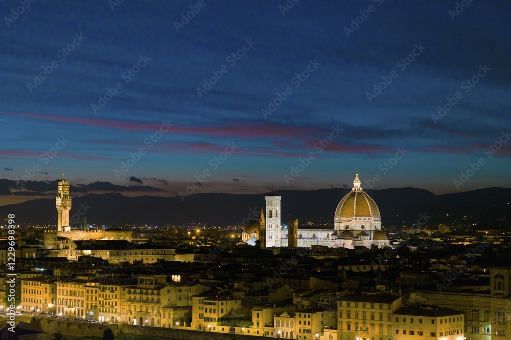 Fototapeta premium Panoramic view of illuminated city at dusk from Michelangelo Square, Piazzale Michelangelo, with Cathedral of Santa Maria del Fiore and Palazzo Vecchio, Florence, Tuscany, Italy, Europe