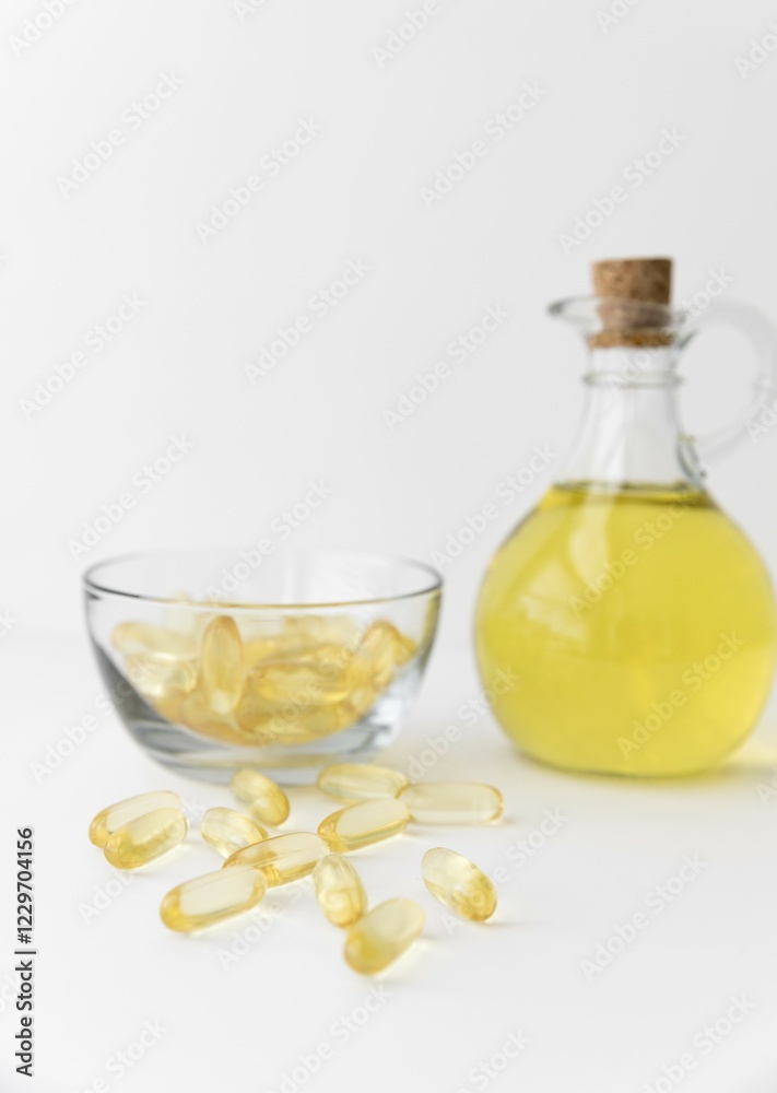 Omega 3 fish oil capsules and bottle on white background Omega 3 fish oil capsules and bottle on white background
