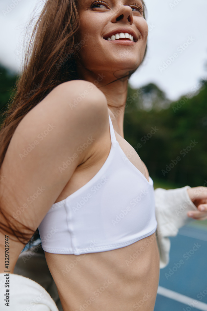 Energetic young woman in a white sports bra enjoying outdoor exercise, expressing joy, with a vibrant green background that conveys a lively, healthy lifestyle Energetic young woman in a white sports bra enjoying outdoor exercise, expressing joy, with a vibrant green background that conveys a lively, healthy lifestyle