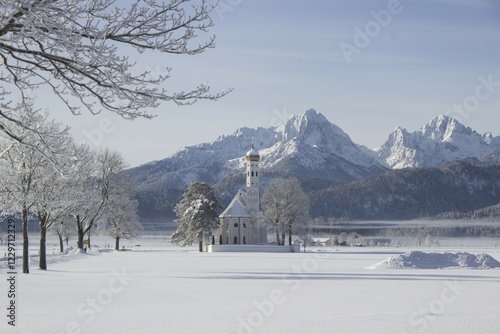 St. Coloman's church in front of snowy mountains in winter, Schwangau, Bavaria, Germany, Europe photo