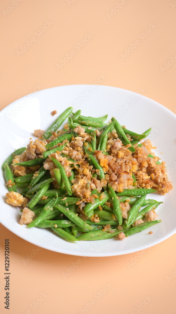 fried green bean with pork on white plate, thai and chinese food