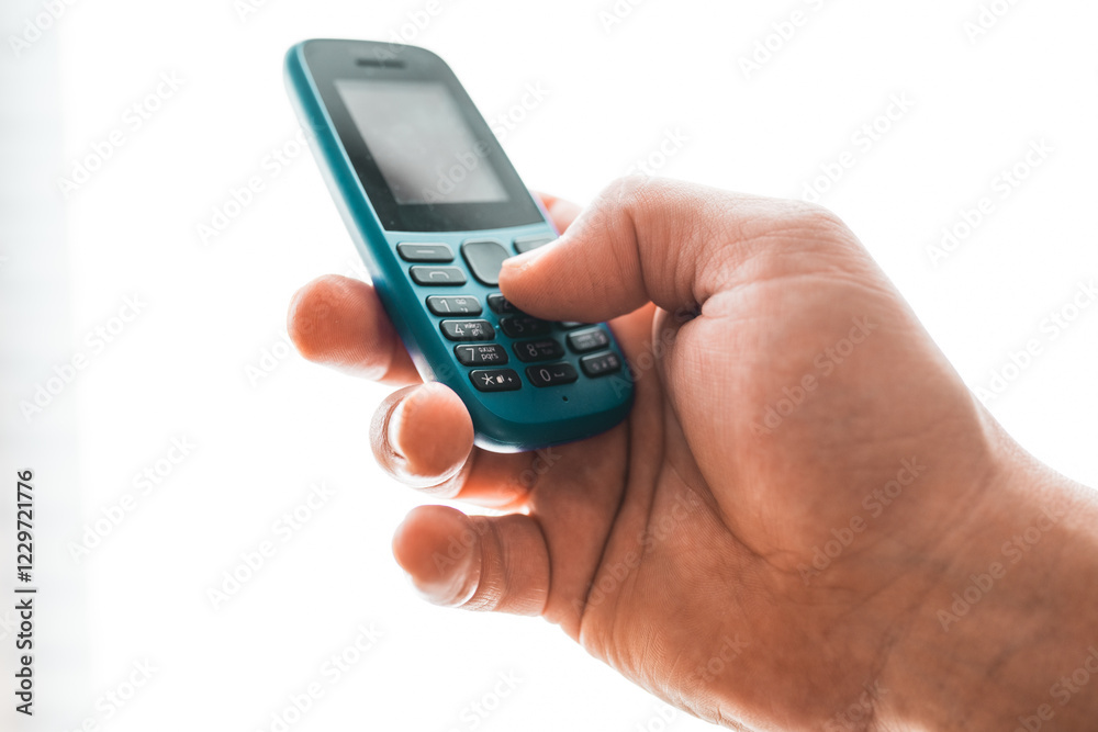 Man hold a dumbphone. An old phone. Digital minimalism concept. Man hold a dumbphone. An old phone. Digital minimalism concept.
