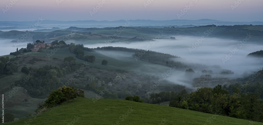 Fototapeta premium Hilly landscape with foggy atmosphere, sunrise, Crete Senesi, province of Siena, Tuscany, Italy, Europe