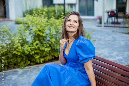 Close-up portrait of a young beautiful woman in a summer park