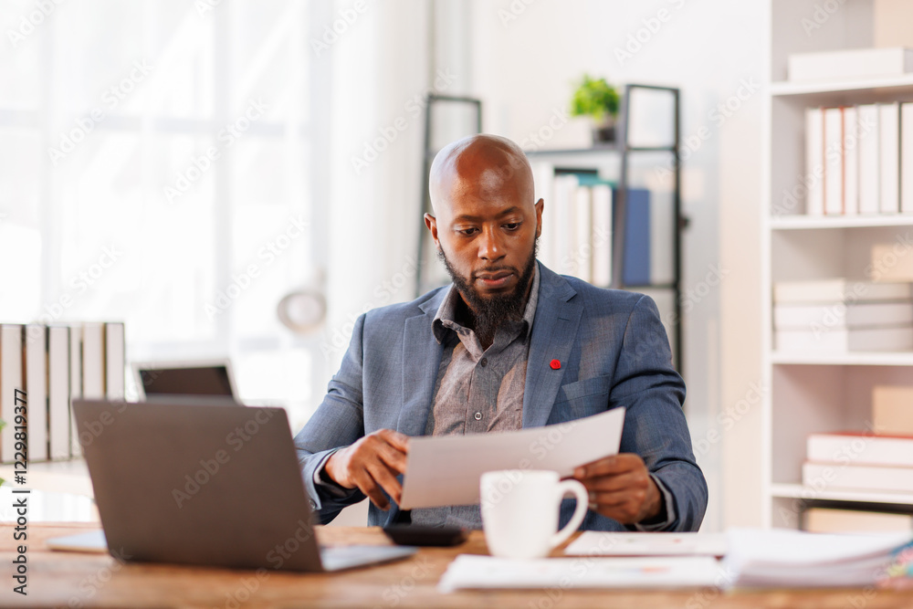 African American business man Accounting using calculating income-expenditure and analyzing real estate investment data report Financial and tax systems concept.
African American business man Accounting using calculating income-expenditure and analyzing real estate investment data report Financial and tax systems concept.