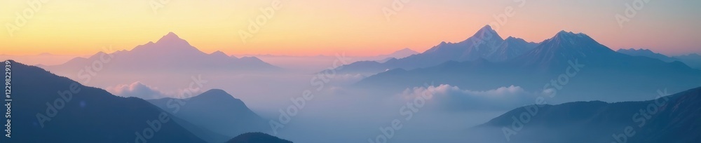 Obraz premium Cloud covered mountain peaks in morning light, sunrise lighting, misty morning