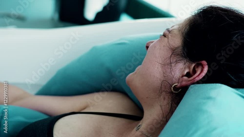 Profile Close-Up of Woman's Face, Painfully Suffering During Labor in Bathtub