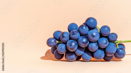 Ripe Dark Purple Grapes With Water Droplets On Beige