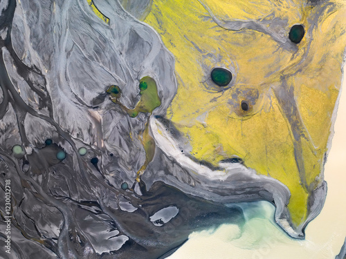 Green ponds in yellow moss and gray sand