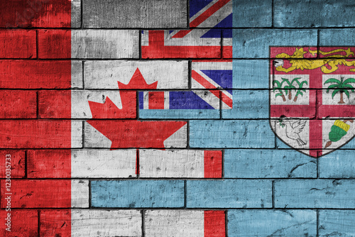 colourful painted big flag of canada and flag of Fiji on a massive old brick wall background. concept