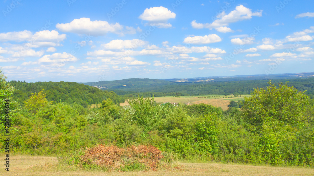 Vast countryside, green forests, rolling hills. Natural idyll, summery. Vast countryside, green forests, rolling hills. Natural idyll, summery.