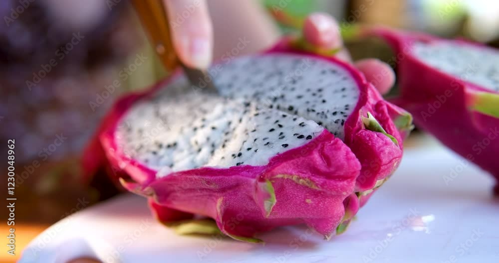 Two halves of dragon fruit pitahaya on a plate isolated on a pink background. High quality 4k footage