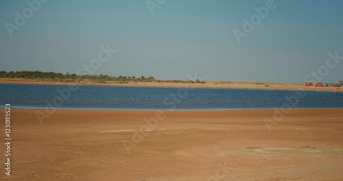 Golden sand close up Sahara desert landscape with lake. photo