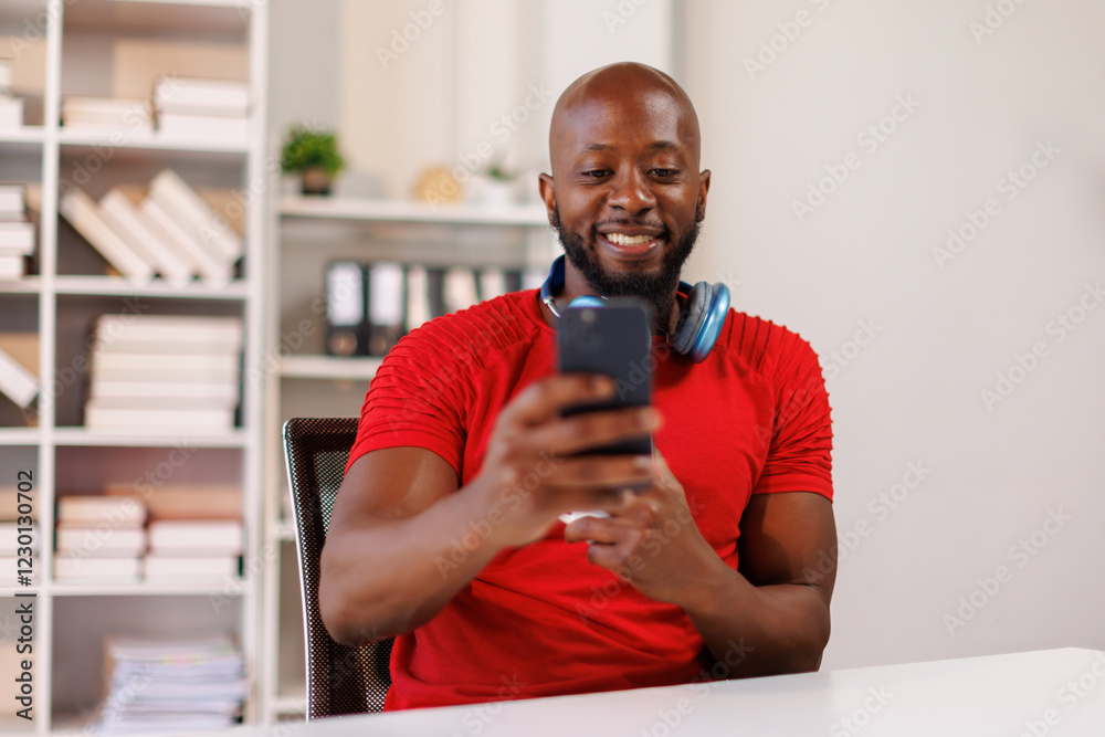Happy african american businessman using phone mobile at workplace texting sms, smiling black man looking at smartphone browsing internet. Happy african american businessman using phone mobile at workplace texting sms, smiling black man looking at smartphone browsing internet.