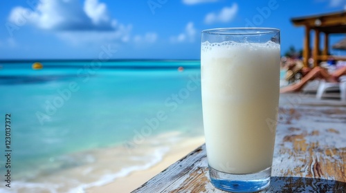 Refreshing coconut drink served on a wooden beach table golden sand and crystal waters in the background ultimate summer refreshment Stock Photo with side copy space photo