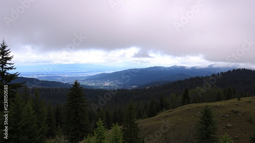 Panoramic View of Mountain Range and Valley Under Cloudy Sky