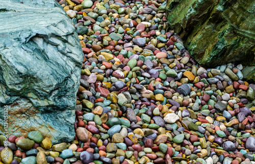 Multicolored rounded stones in the interior of a flowerbed near a recreation area, USA