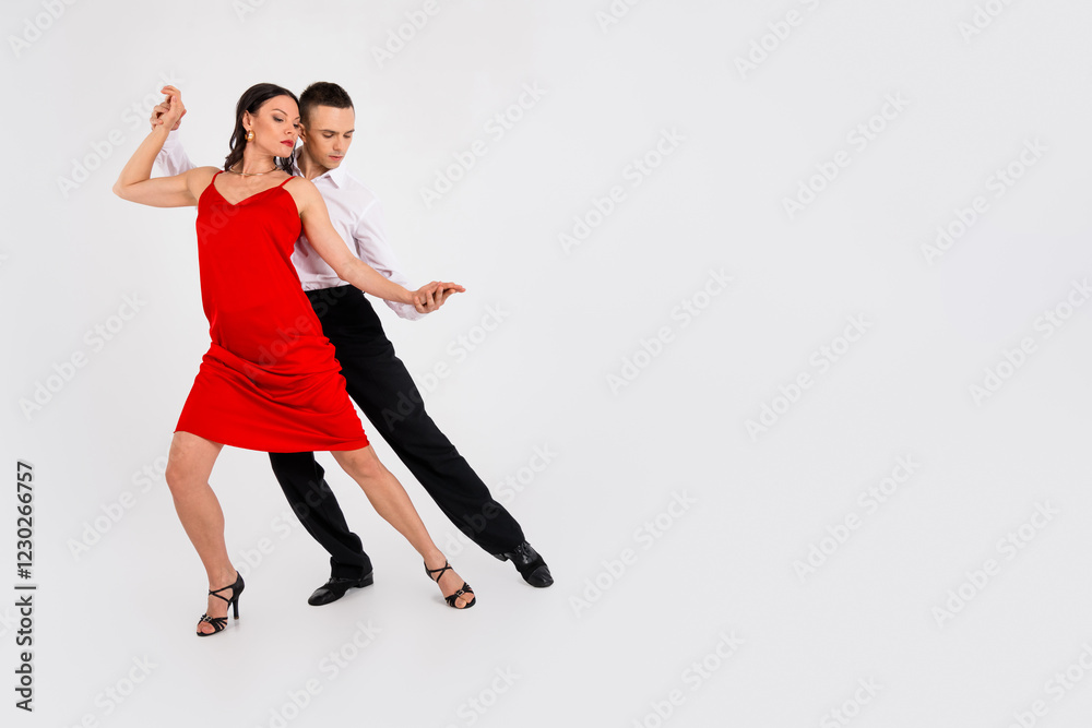 Full body portrait of two young elegant people dancing empty space ad isolated on white color background