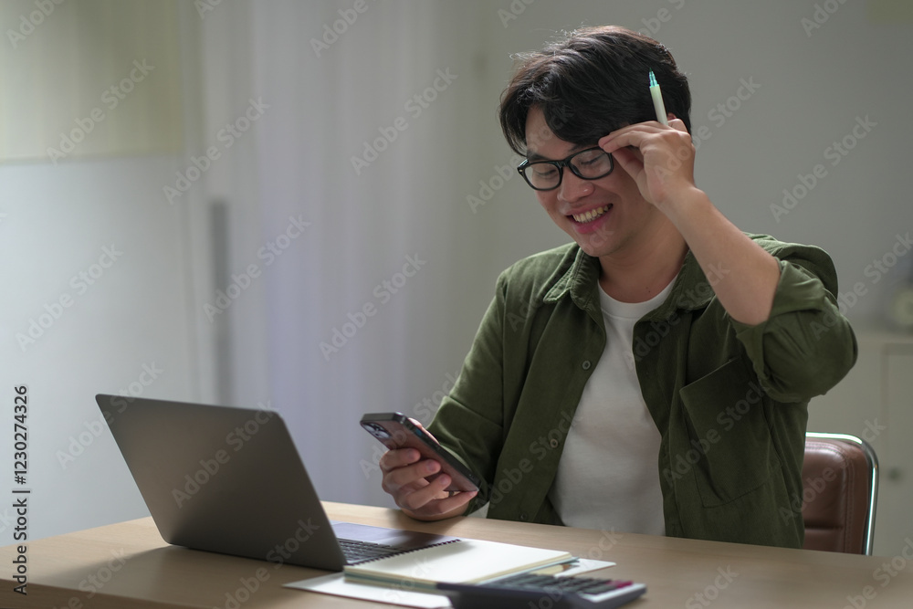Man enjoying a productive work session from his bright, modern living space. Young man working at home. Home office. , freelance Man enjoying a productive work session from his bright, modern living space. Young man working at home. Home office. , freelance