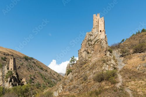 old Medieval Ruined Military Towers of Vovnushki in Ingushetia, Russia blue background sky photo