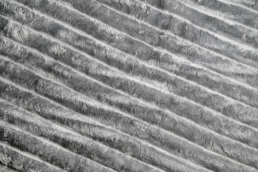 Close up texture of soft, fluffy gray fleece fabric with diagonal folds. Perfect for backgrounds, textile patterns, upholstery, interior design, or cozy-themed creative projects Close up texture of soft, fluffy gray fleece fabric with diagonal folds. Perfect for backgrounds, textile patterns, upholstery, interior design, or cozy-themed creative projects