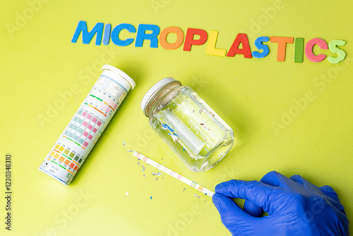 Collection of water sample contaminated with microplastics in test tube. contamination by plastic particles. Environmental problem research for recycling PH test in laboratory.