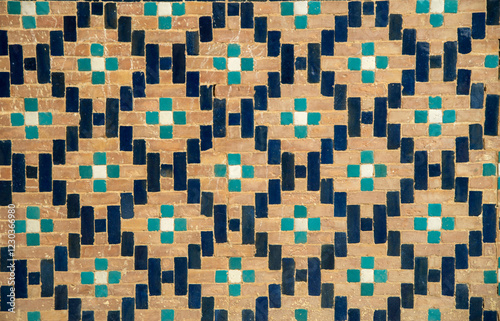 Closeup wall decorated with colored pattern of eastern, ceramic, porcelain mosaic in Uzbekistan, Asia